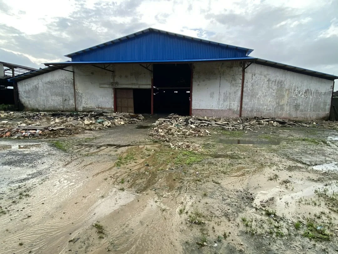 Existing factory facade and debris before renovation