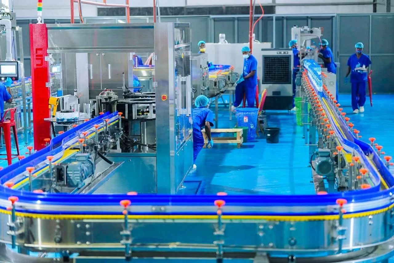 Conveyor system carrying bottles through the facility