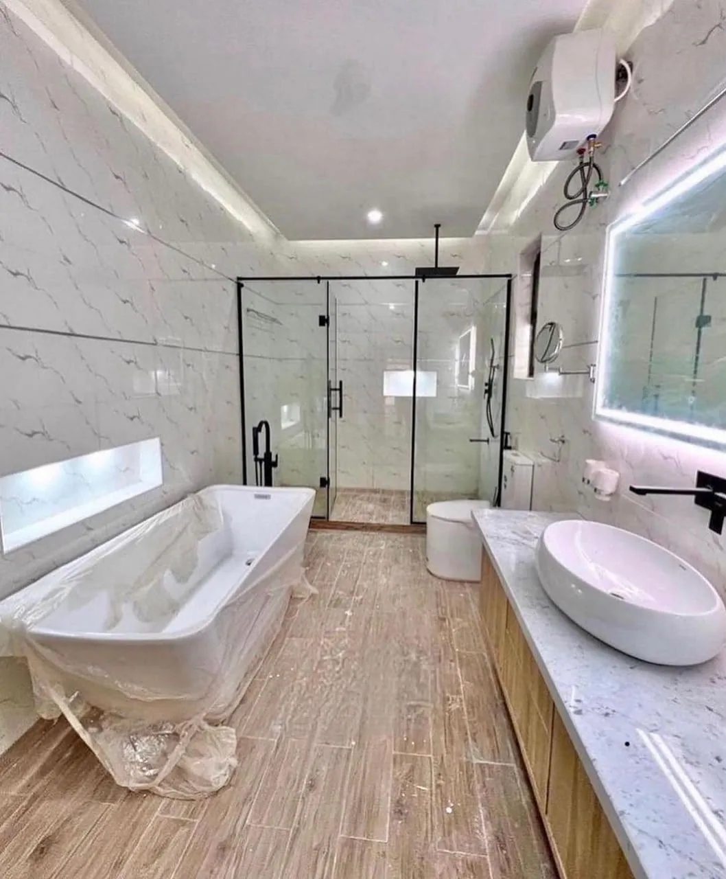 Completed bathroom interior with bathtub, shower and vanity