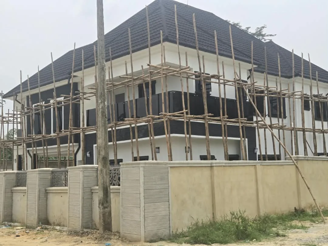 Corner view of residence undergoing facade finishing