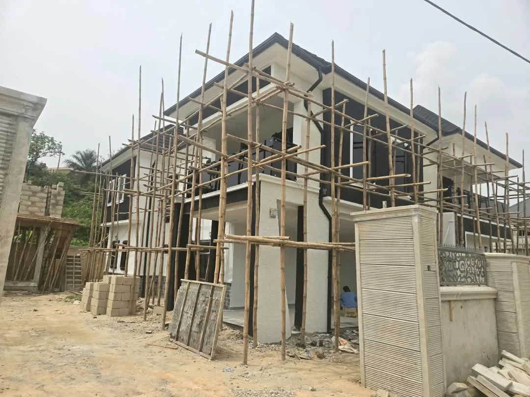 Front view of residence with scaffolding and finished roof